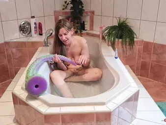 Watch this kinky teen's solo session with a massive tattooed monster in the water