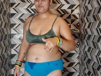 Indian BBW Puma Bhabhi masturbates with her massive natural tits while Levelly Gig watches in the bathroom